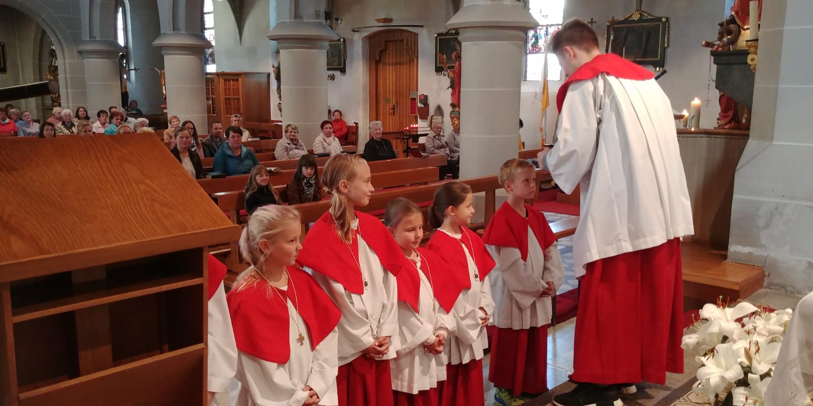 Oberministrant Ströhlein übergibt die Ministrantenkreuze